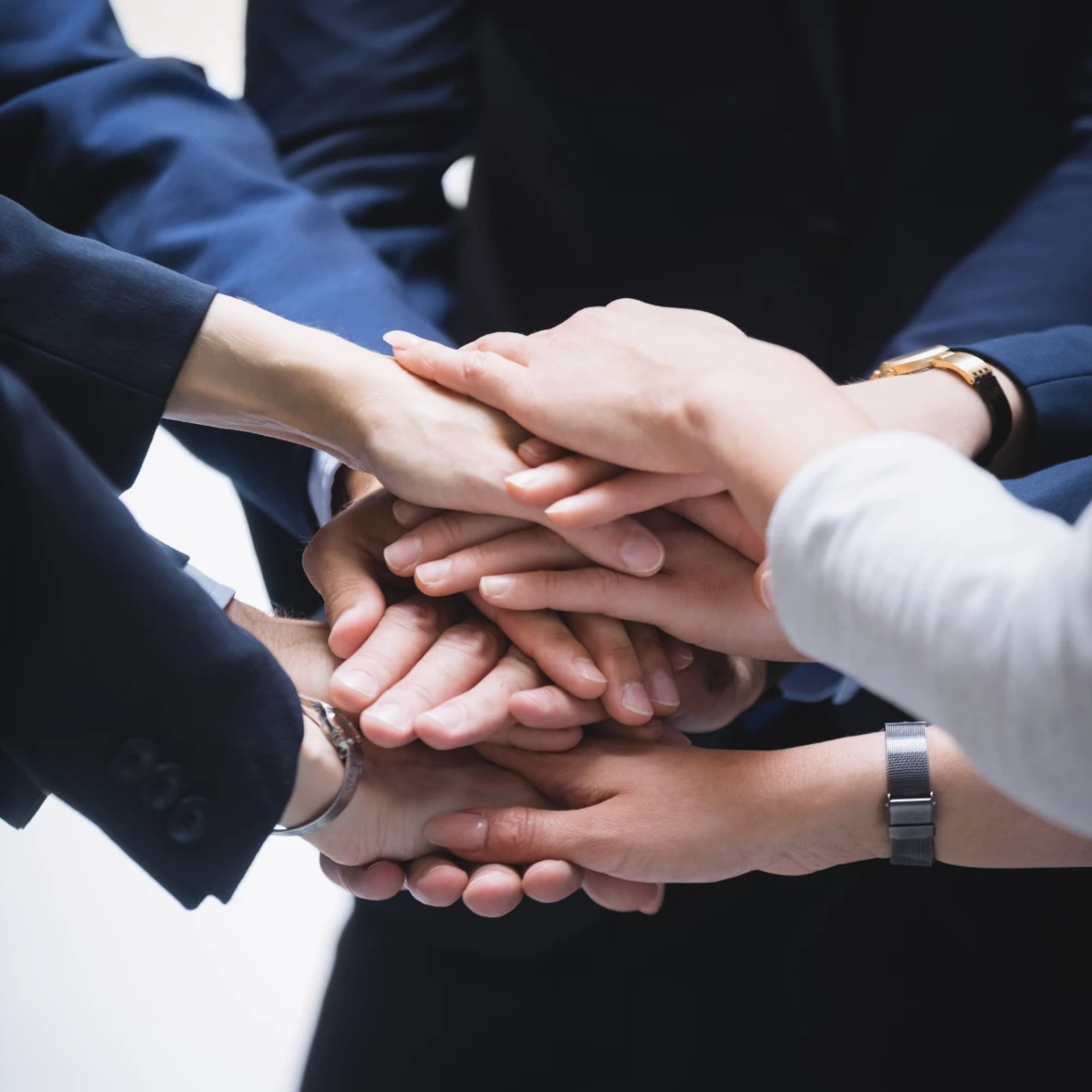 Team collaboration - hands stacked together